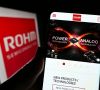 Stuttgart, Germany - 12-04-2022: Person holding cellphone with website of Japanese electronics company Rohm Semiconductor on screen with logo. Focus on center of phone display.